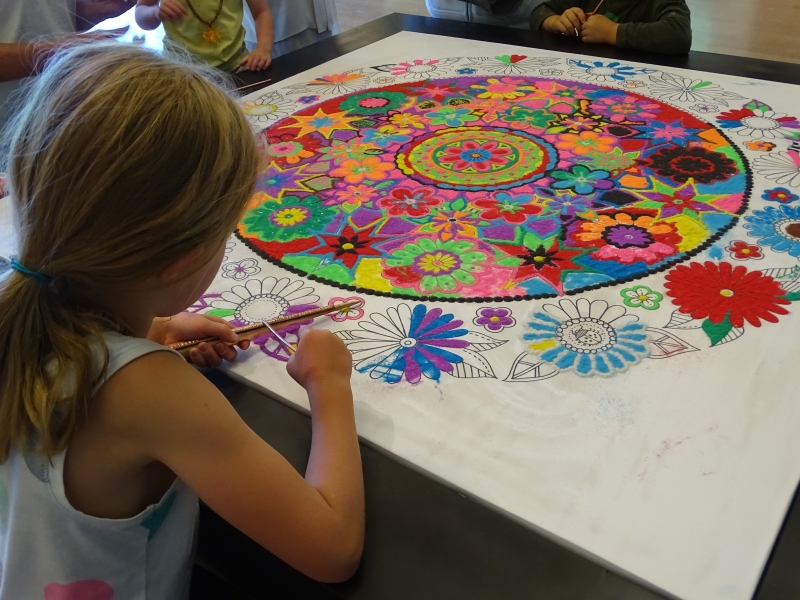 Mandala 2015 - Child at work on the Community Sand Painting