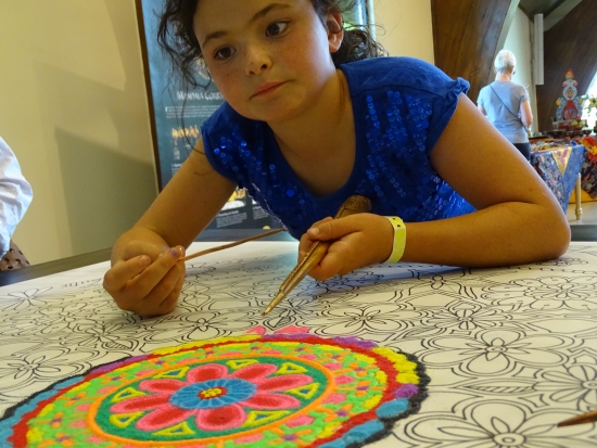 The Community Sand Painting enthralled young artists.