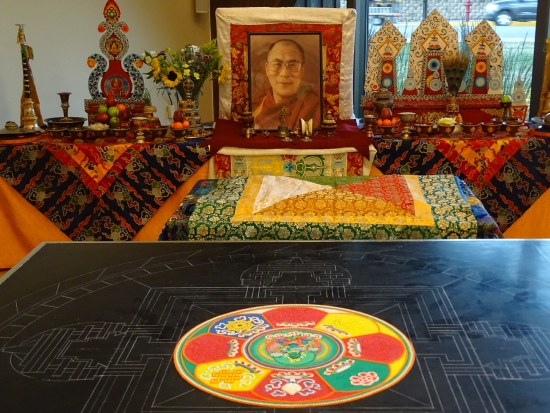 The heart of the Green Tara mandala rests under the watchful eye of the Dalai Lama.