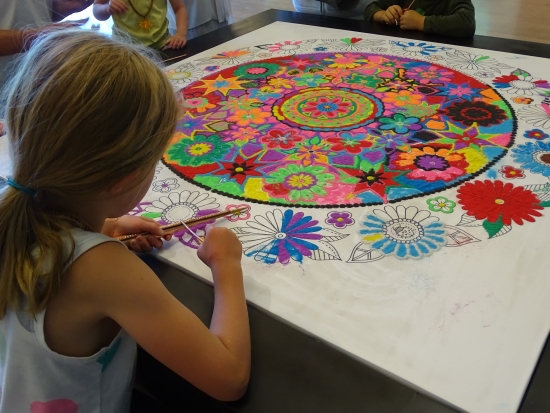 Last time this little artist sand painted was 2010, when she could barely reach the Community Sand Painting table.