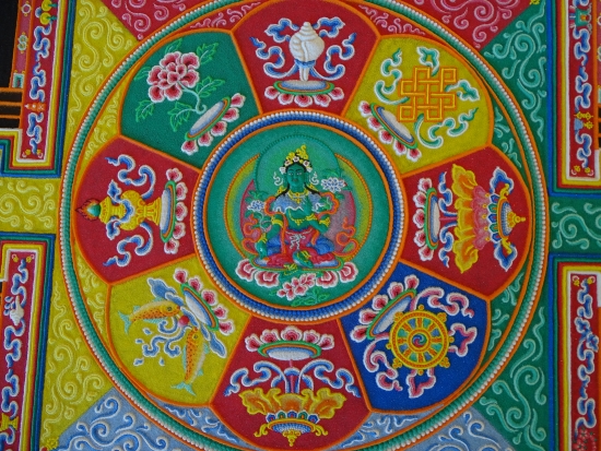 Green Tara surrounded by eight auspicious symbols.