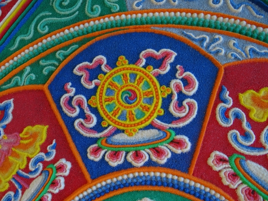 The Eight Spoked Wheel represents the noble eightfold path of the Buddhadharma.