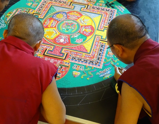 The monks added dozens of tiny items to the mandala today, from bitty snow lions to blossoming lotus flowers.