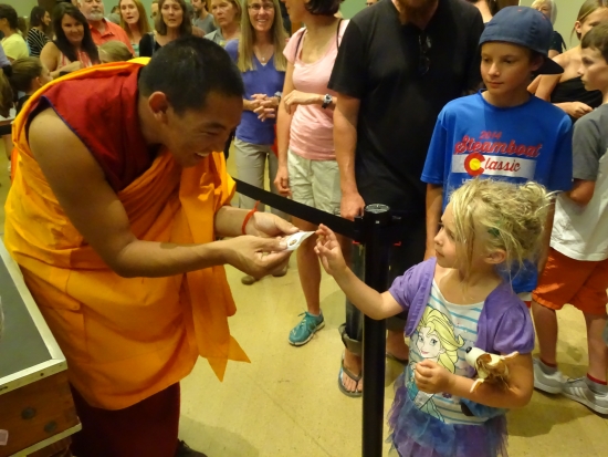The monks offer mementos -- tiny bags of the mandala sand for a grateful community.