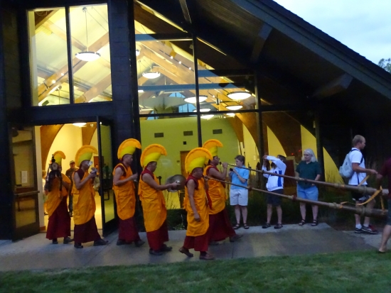 The monks exit Library Hall, heading for the Yampa River with the sandy remains of the Green Tara mandala in an urn.